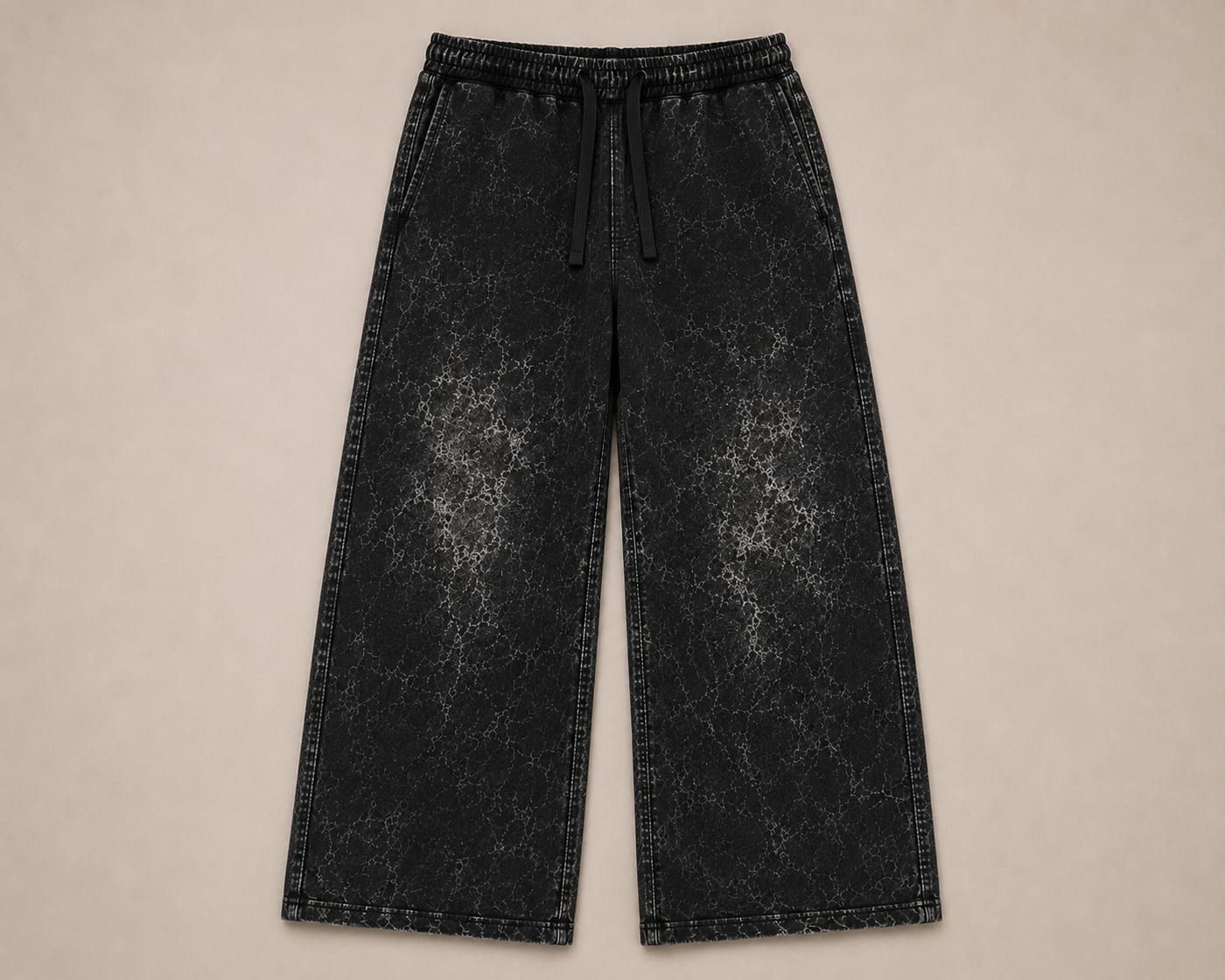 Black 400 GSM French terry wide-leg acid wash sweatpant laid flat, showing the full leg opening