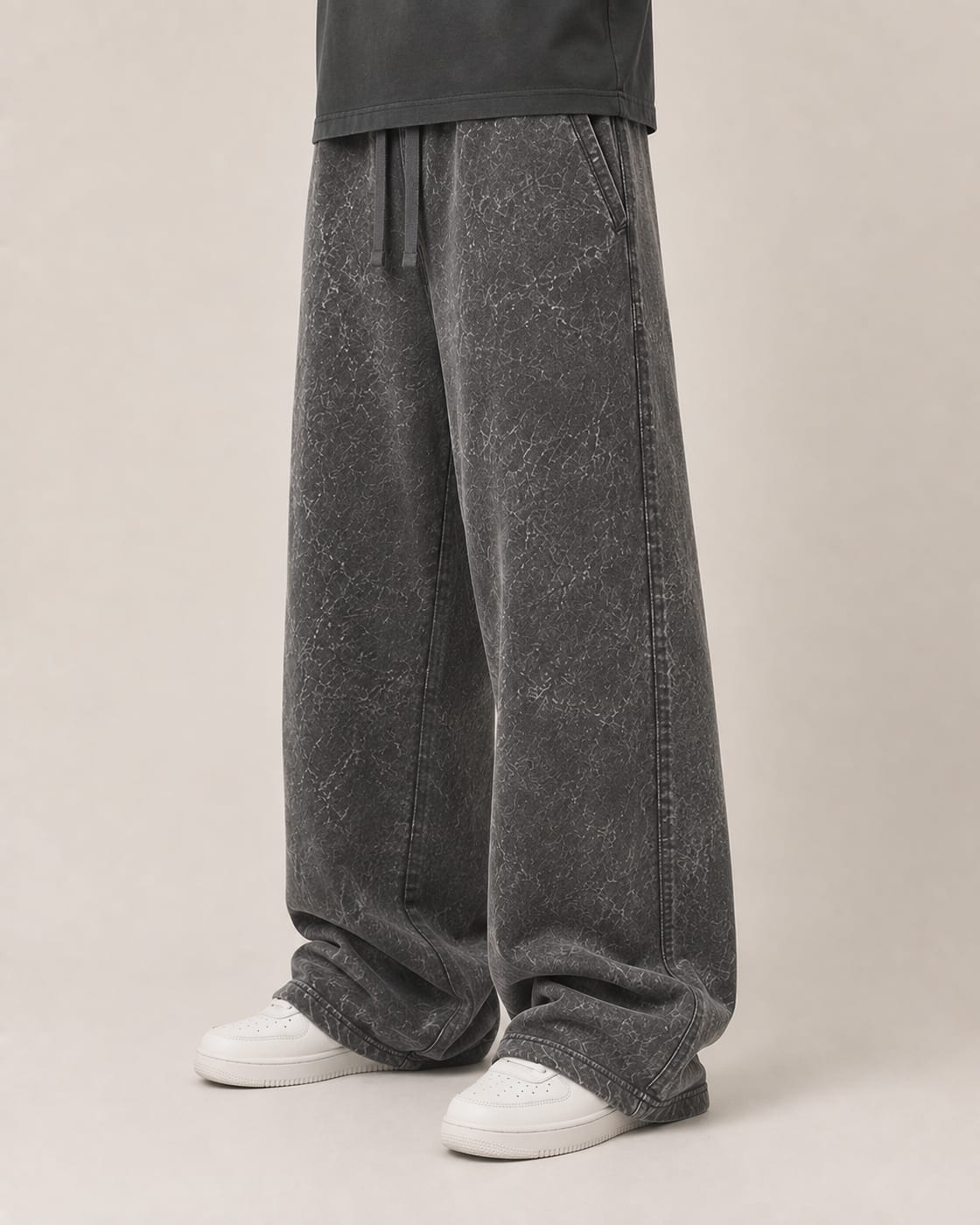 Model wearing charcoal 400 GSM acid wash wide-leg sweatpants, showing the relaxed leg break
