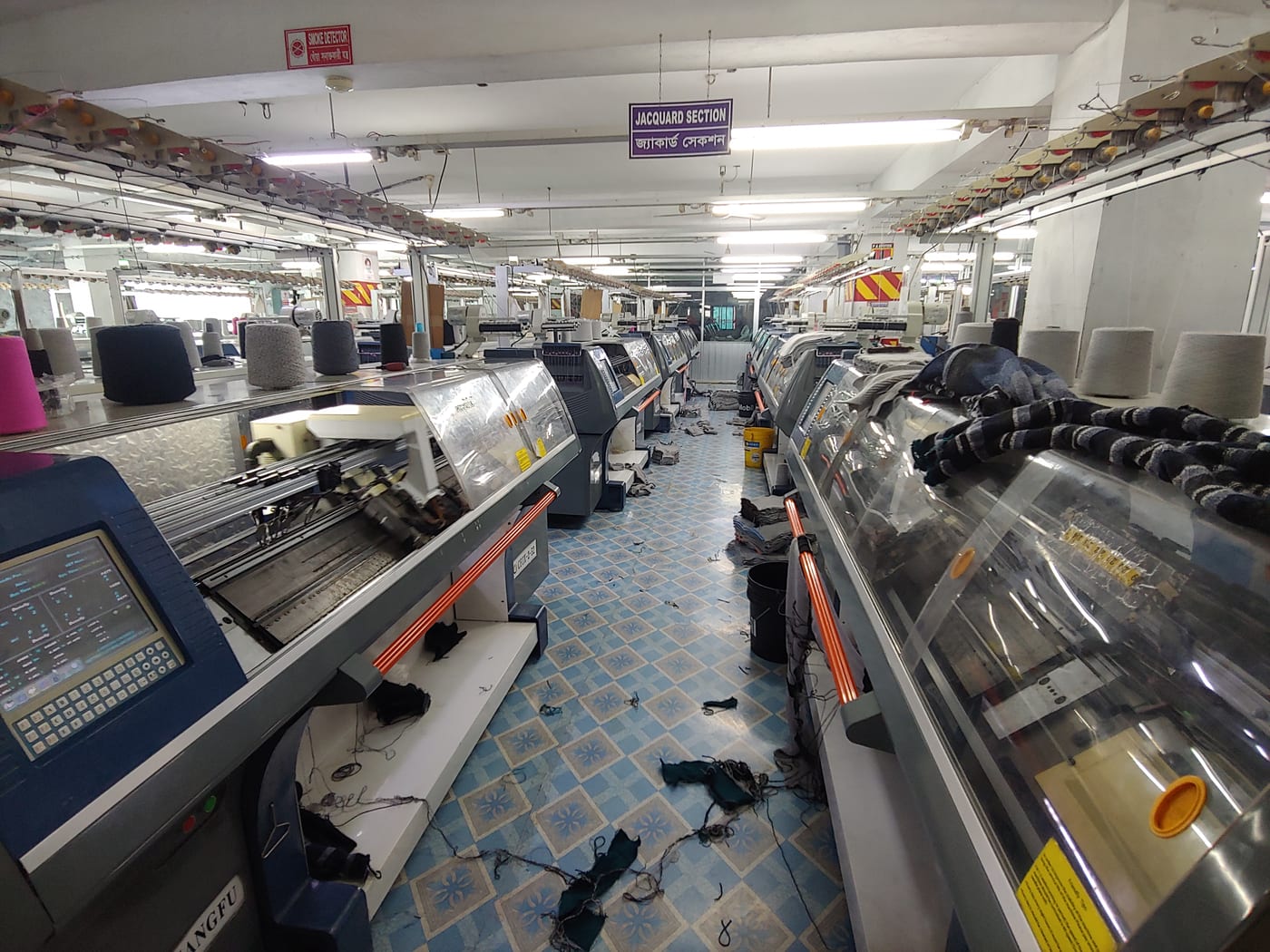 Flat-bed knitting machines producing shaped sweater panels