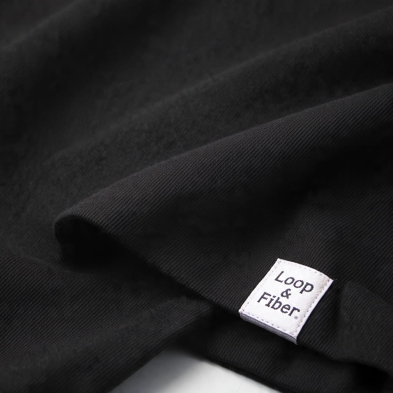 Custom woven brand label on a garment hem
