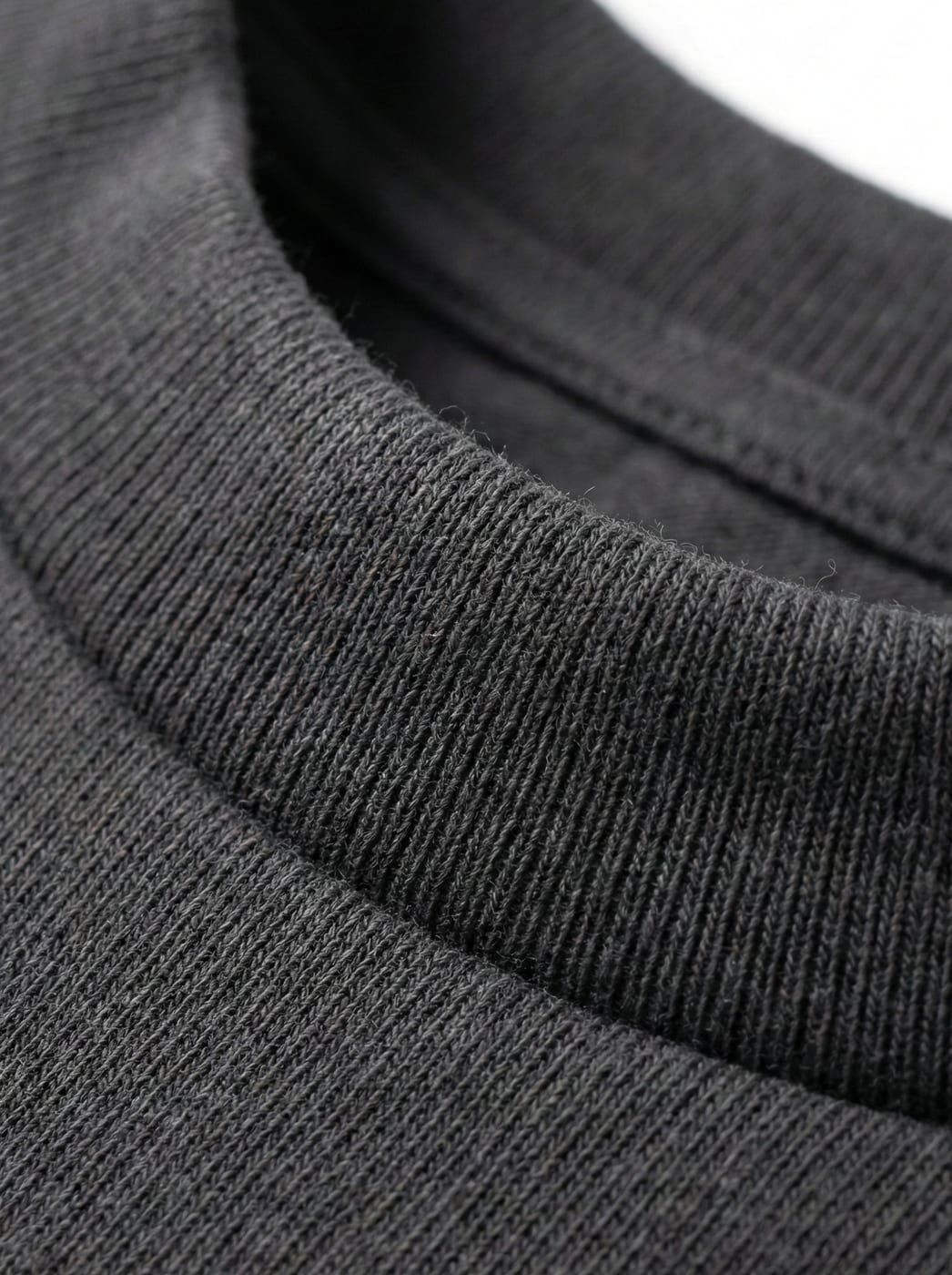 Close-up of ribbed collar construction on a charcoal heavyweight tee